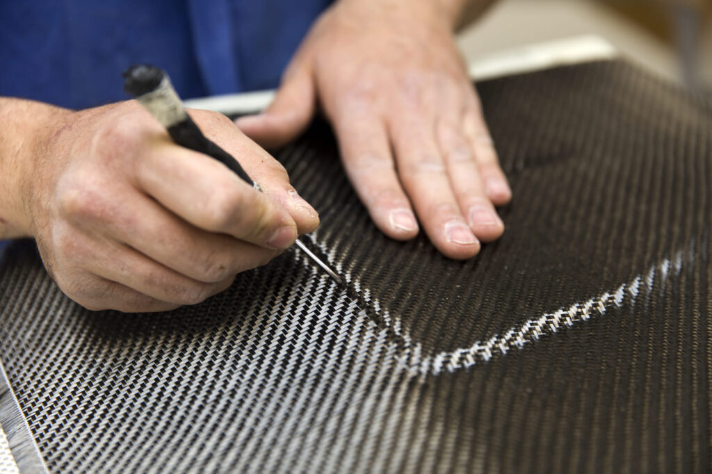 Carbon fiber maintenance being performed by a technician using a precision tool